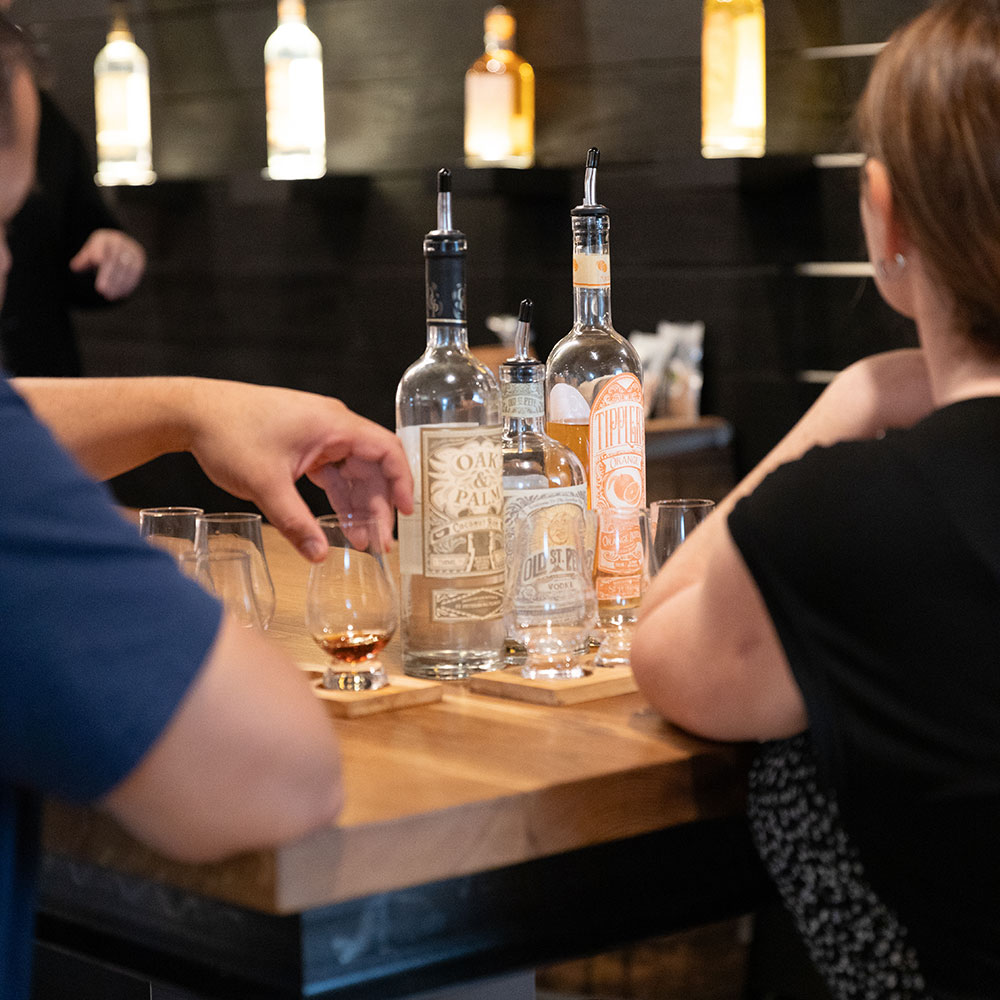 A person pouring a drink into a glass.